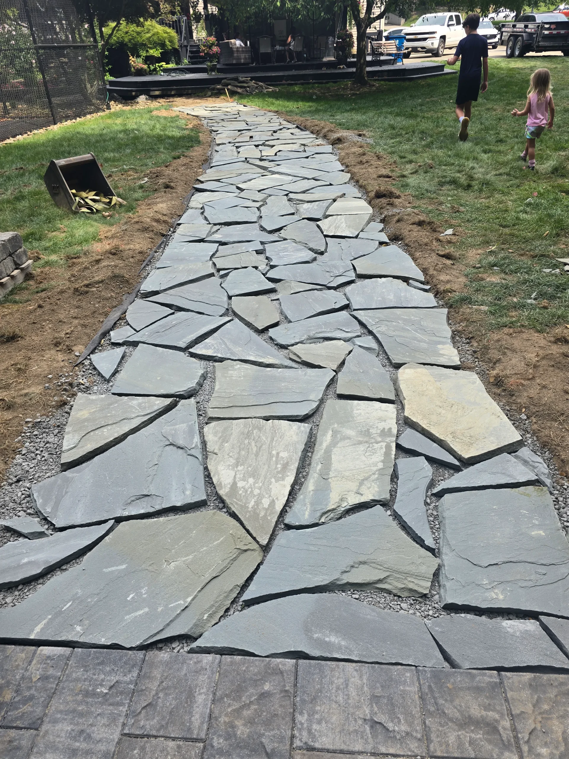 Professional landscaping with lawn, plants, and outdoor design features